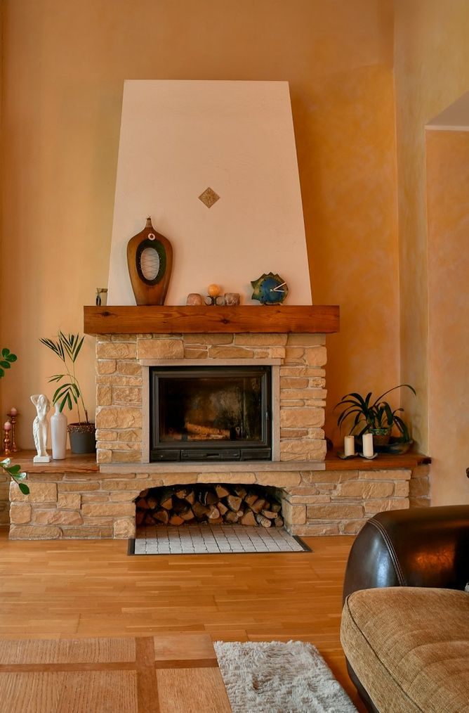 Bright living room with a stone fireplace and large window