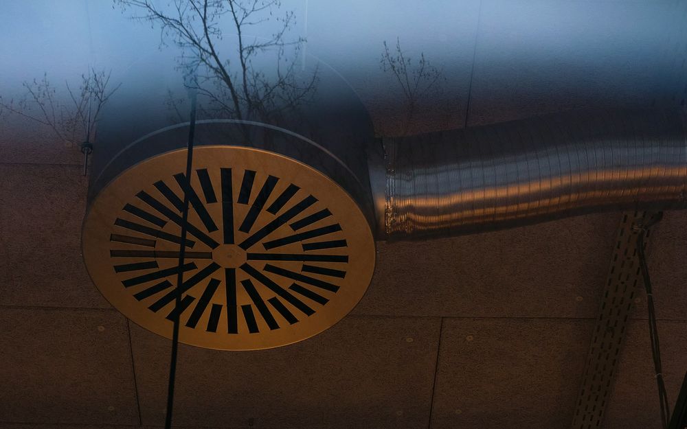 Round air diffuser connected to ventilation ductwork